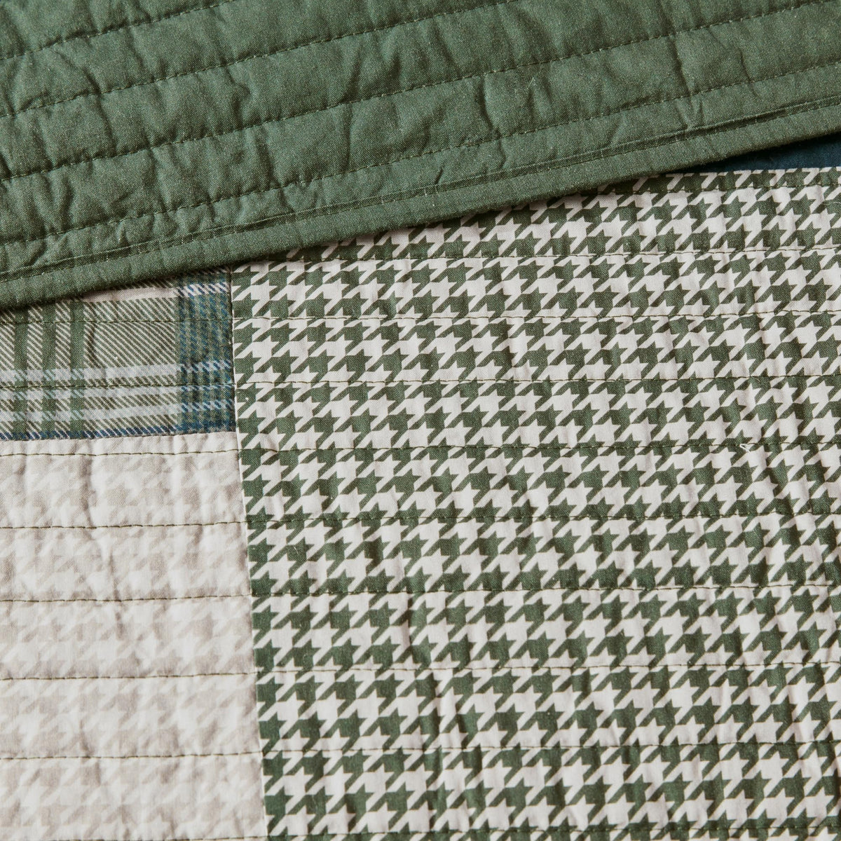 Woolrich Mill Creek quilt with navy accents elevates a calm, lodge-inspired bedroom.