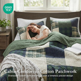 Woolrich Mill Creek patchwork quilt folded on oversized twin bed for easy styling.