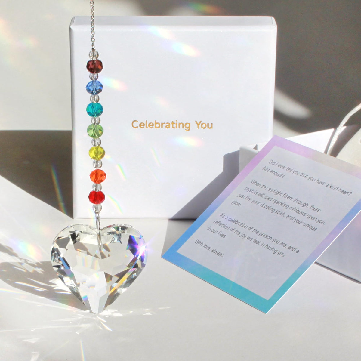 WOOWA crystal heart suncatcher close-up catching sunlight and rainbow light