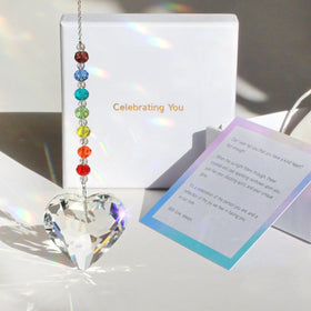 WOOWA crystal heart suncatcher close-up catching sunlight and rainbow light