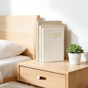 Styled on a living room shelf with vases and photos.