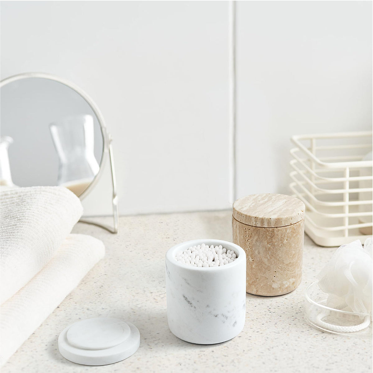 WORHE marble apothecary jar vanity keeps cotton swabs and pads accessible and stylish.
