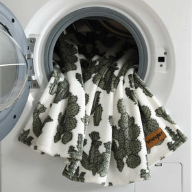 Wrangler blanket layered on bed to enhance texture and comfort.