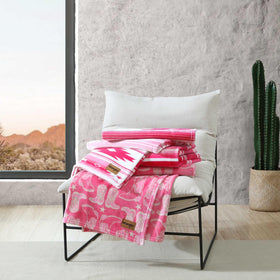 Wrangler blanket folded on chair for a cozy reading nook.