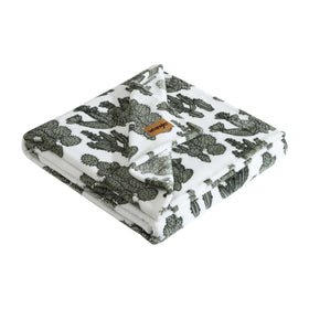 Wrangler plush blanket in cactus garden green adds cozy warmth to living room.