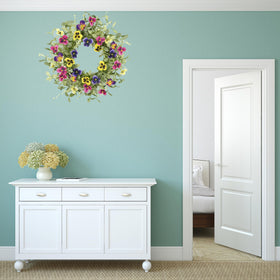 WreathDream pansy accents on wreath add vibrant color and texture.