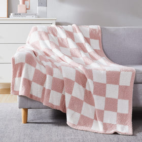 WRENSONGE pink checkered throw blanket on couch adds cozy color and warmth.