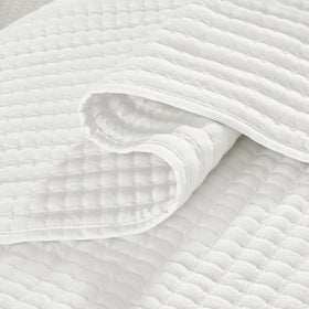 WRENSONGE pillow shams and quilt set accent a cozy bedroom.