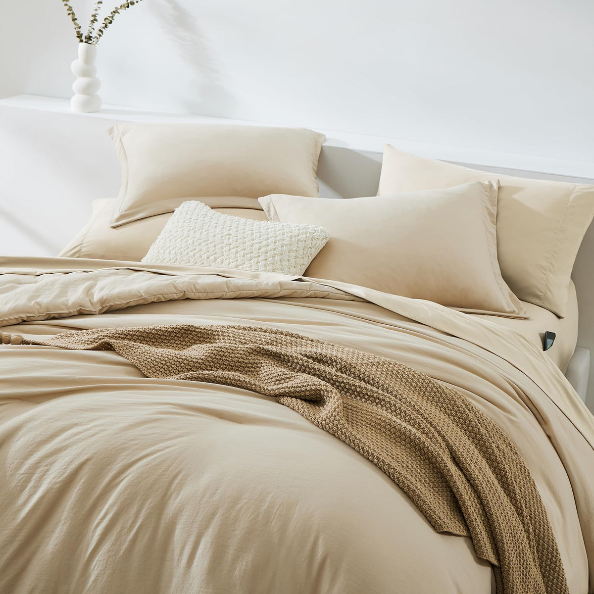 WRENSONGE beige comforter detail highlights soft microfiber for a plush, quiet night's sleep.