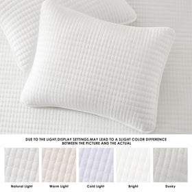 WRENSONGE travel-friendly quilt shown on a cozy bed.