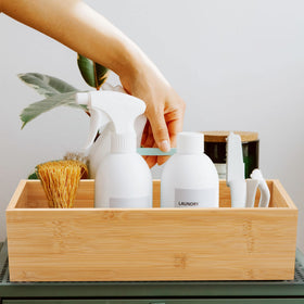 XIMISISE bamboo basket on kitchen counter holding condiments and small items.