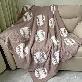XING7DAY Cozy baseball-pattern blanket on brown fabric provides warm comfort.