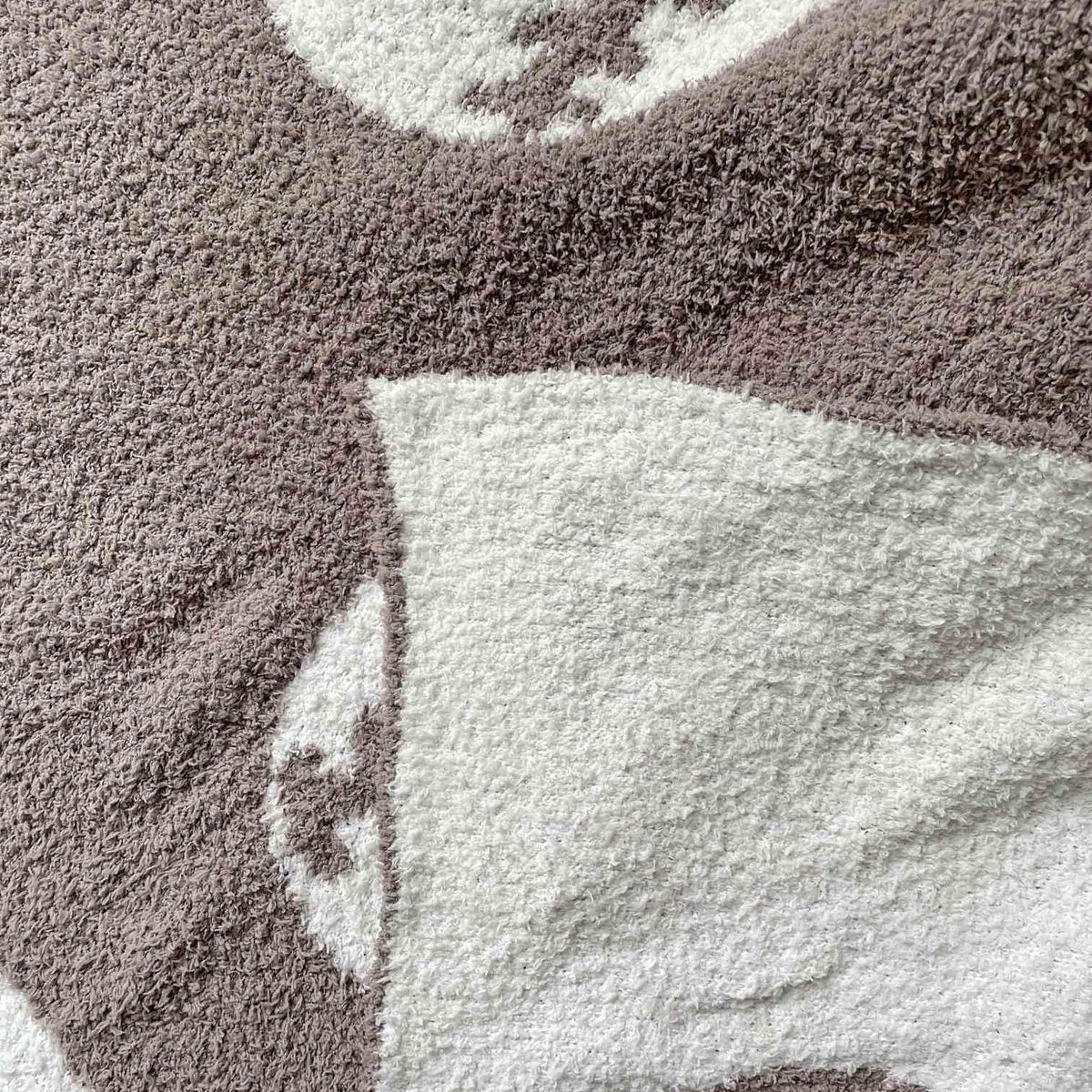 XING7DAY Sports-inspired blanket draped for lounge or couch use.