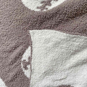 XING7DAY Sports-inspired blanket draped for lounge or couch use.
