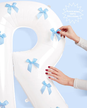 xo Fetti blue adhesive bows enhance balloon decor with chic accents
