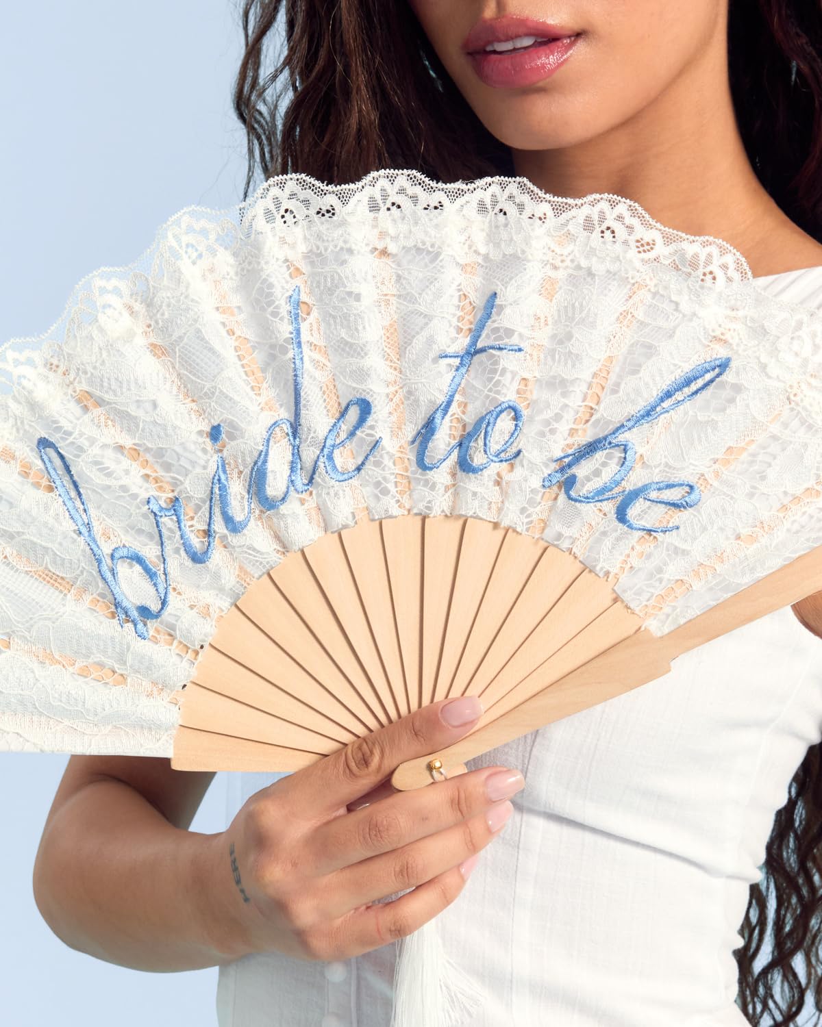 xo Fetti bride-to-be blue embroidery adds festive charm to wedding day moments.