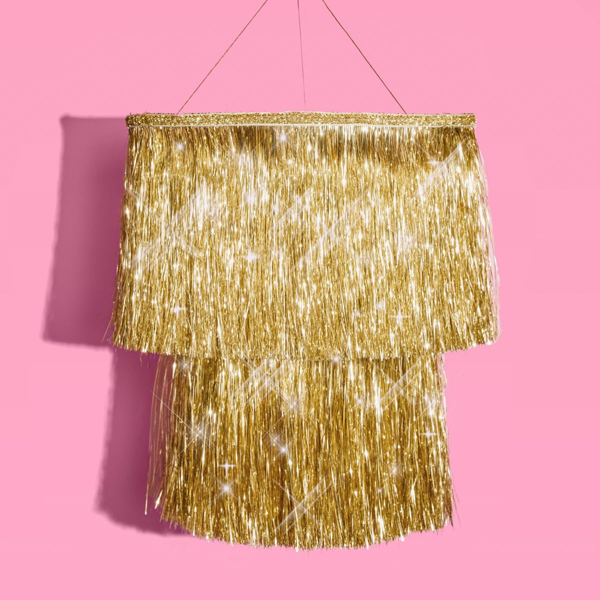 xo Fetti gold-fringe chandelier adds luxe sparkle to party setup