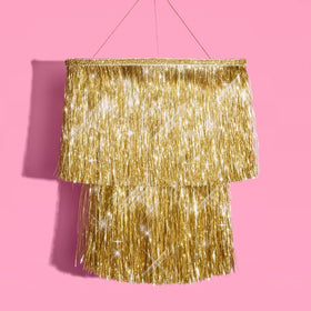 xo Fetti gold-fringe chandelier adds luxe sparkle to party setup