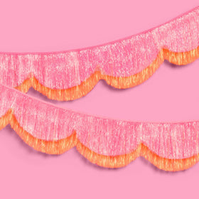 xo-fetti pink-orange scallop fringe banner front view adds warm glow to parties.
