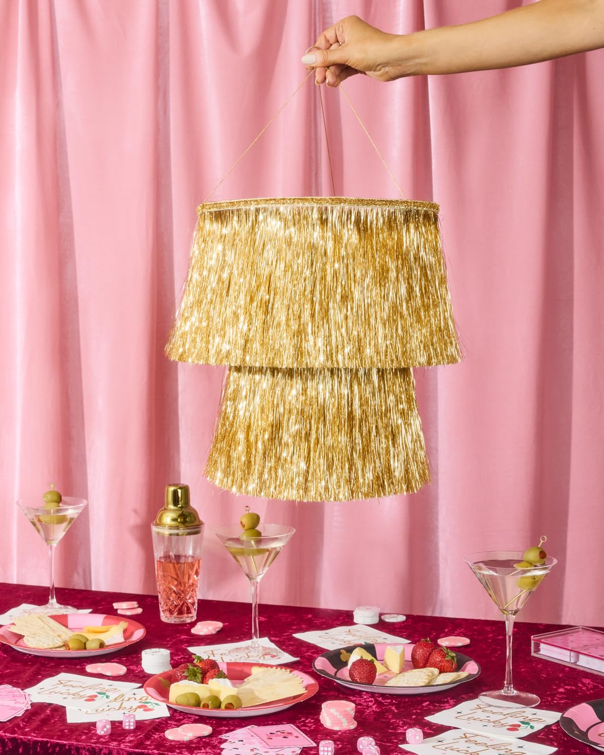 xo Fetti two-layer gold fringe chandelier creates a dramatic backdrop