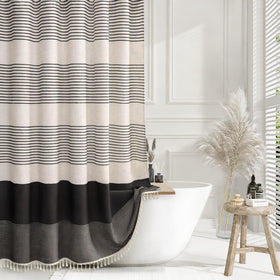 XOGUIBO black shower curtain with boho striped tassels for warm bathroom style.