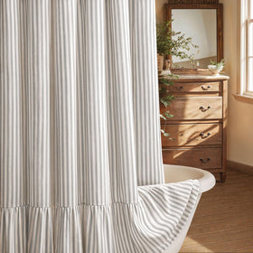 XOGUIBO farmhouse shower curtain with a ruffle hem adds rustic charm to the bathroom.
