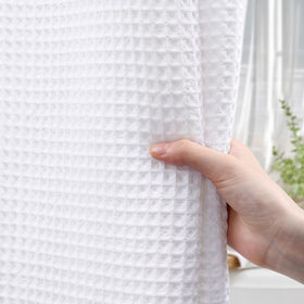 XOGUIBO heavyweight curtain stays in place for privacy during showers.