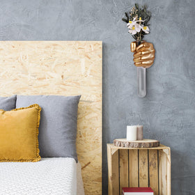 Contemporary wall sculpture by XYQXYQ adds a striking gold accent.