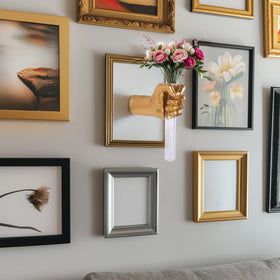 XYQXYQ gold hand sculpture complements living rooms with eclectic style.