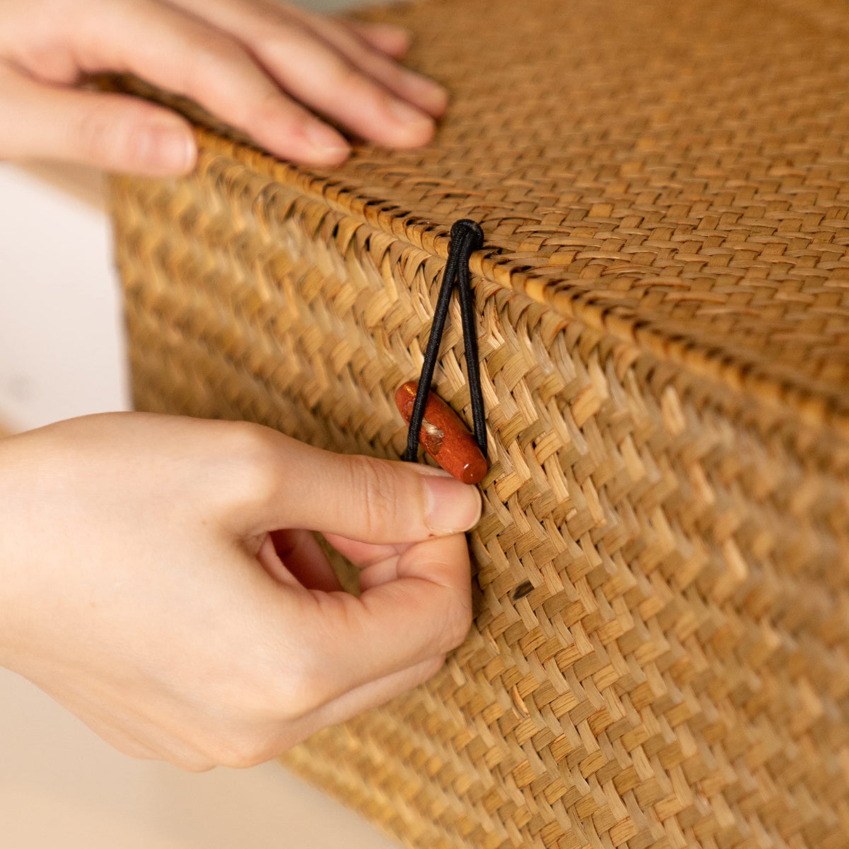 YANGQIHOME rattan storage organizer on a bedroom shelf reduces clutter.