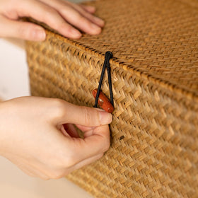 YANGQIHOME rattan storage organizer on a bedroom shelf reduces clutter.