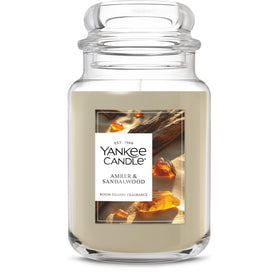 Yankee Candle Amber & Sandalwood jar glows warmly, delivering long-lasting room fragrance