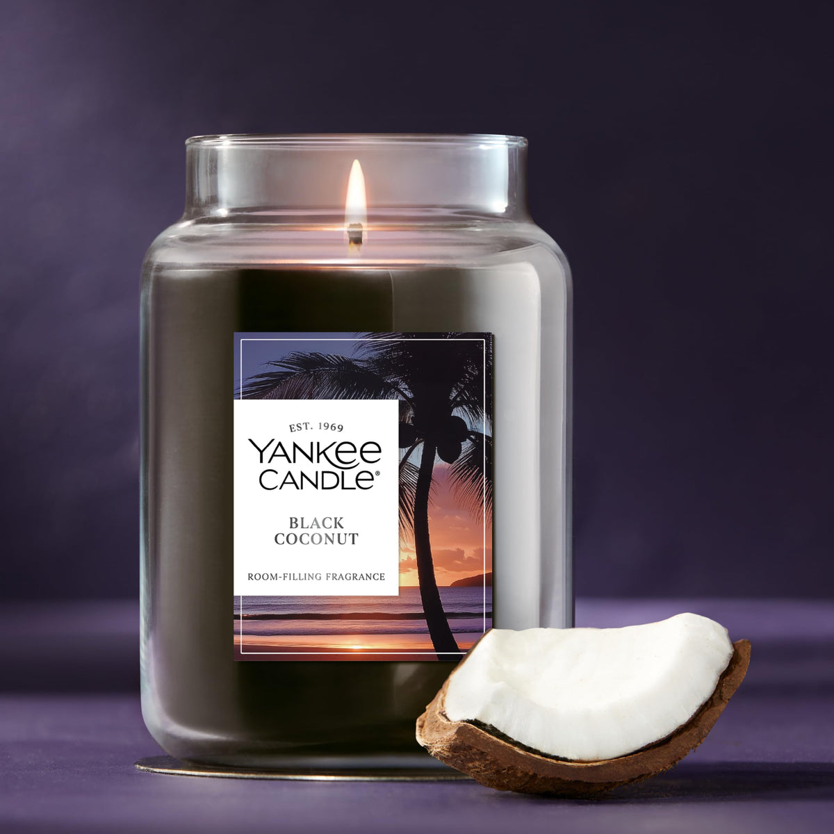 Yankee Candle Black Coconut 22oz jar resting on a cozy living room table.