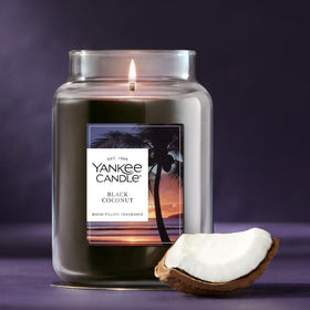 Yankee Candle Black Coconut 22oz jar resting on a cozy living room table.