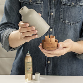 Yankee Candle room spray dispense shows quick mist for refresh.