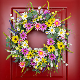 Yawwind spring wreath on exterior wall enhances curb appeal.