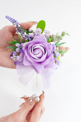 Yelinart boutonniere with pearl brooch detail for secure attachment.