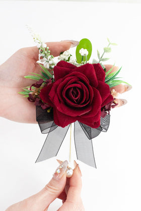 Yelinart burgundy boutonniere closeup highlighting pearl pin