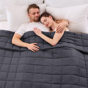 YesCool weighted blanket on a queen bed in grey promotes restful sleep.