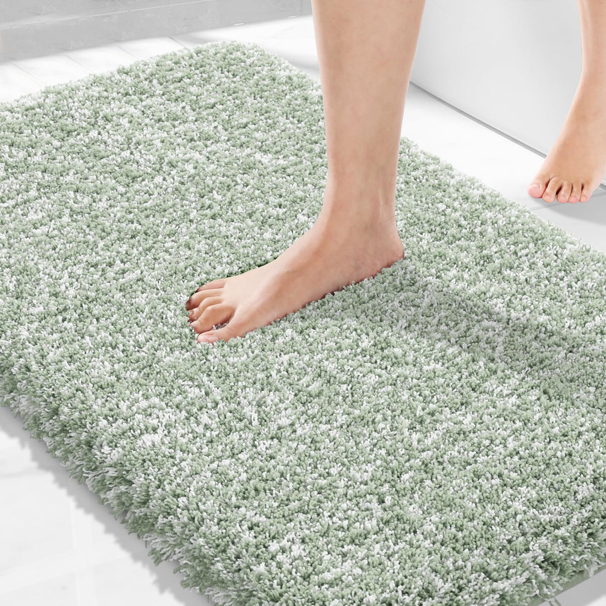 Yimobra light-green rug with non-slip hexagon bottom for safer bathroom floors.