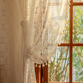 Vintage floral crochet panels adding warm ambience to windows.