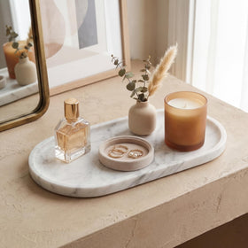 Narrow vanity counter with YKAJO tray beside the sink.