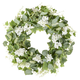 YNYLCHMX wreath on front door with green eucalyptus and white flowers for welcoming curb appeal