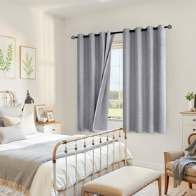 YoungsTex grey linen blackout curtains hung on a rod in a cozy room.