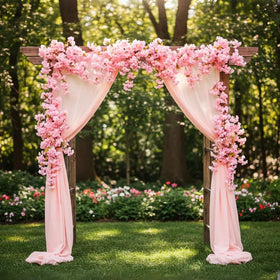 YRIOWMI cherry blossom garland draped on an arch for a wedding backdrop