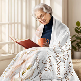 The YSBLGWE floral motif blanket with pink blooms adds elegant decor.