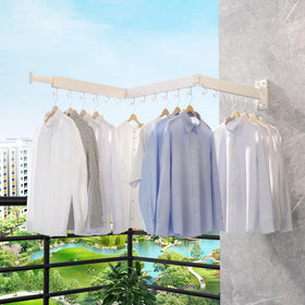 ZdwCyl wall-mounted clothes rack by a sunny window for drying.