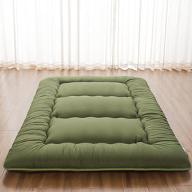 Zelladorra Japanese floor mattress rolled up in storage bag for easy transport.