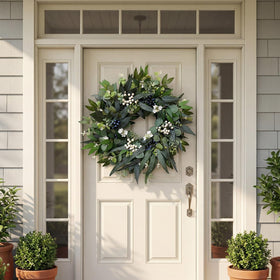 Zhoree eucalyptus wreath with white and blue berries for entrance decor.