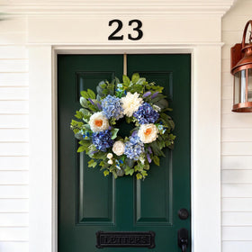 Zhoree wreath on a fireplace mantle with silk flowers for cozy ambiance